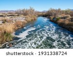 Las Vegas Wash flowing swiftly towards Lake Mead below a weir at Clark County Wetland Park
