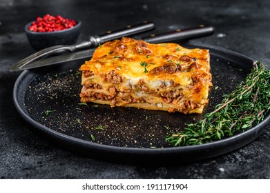 Lasagna With Mince Beef Meat And Tomato Bolognese Sauce On A Plate. Black Background. Top View