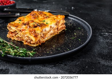 Lasagna With Mince Beef Meat And Tomato Bolognese Sauce On A Plate. Black Background. Top View. Copy Space