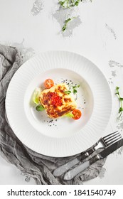 Lasagna With Tomato And Green Leaf. Fish With Bechamel Sauce. White Restaurant Plate On Light Table