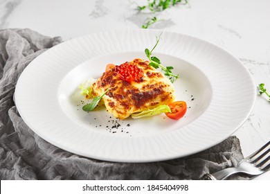 Lasagna With Tomato And Green Leaf. Fish With Bechamel Sauce. White Restaurant Plate On Light Table