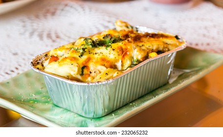 Lasagne ready meal in foil container on the table