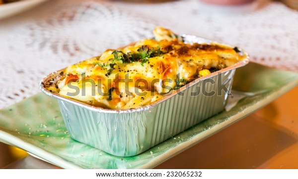 Lasagne ready\
meal in foil container on the\
table