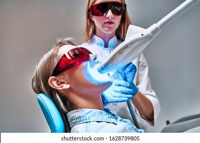 Laser Bleaching Teeth At Dantist Room. Teeth Whitening For Woman. Bleaching Of The Teeth At Dentist Clinic.