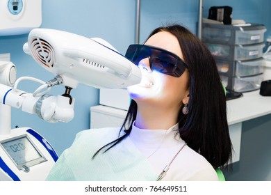 Laser Bleaching Teeth At Dantist Room. Teeth Whitening For Woman. Bleaching Of The Teeth At Dentist Clinic. 