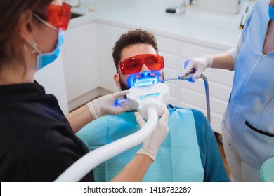 Laser Bleaching Teeth At Dentist Room. Teeth Whitening For Men. Bleaching Of The Teeth At Dentist Clinic.