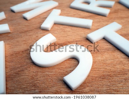 laser cut acrylic white letters on wood.