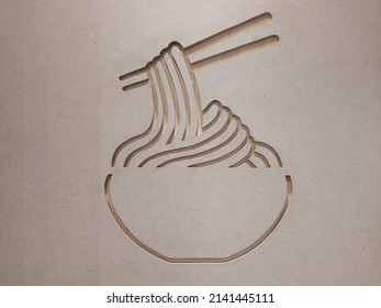 laser cut image on wood in the form of a bowl of noodles lifted using chopsticks - Shutterstock ID 2141445111