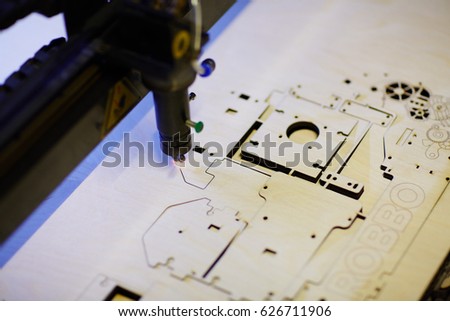 Laser cutter engraving details from veneer wood