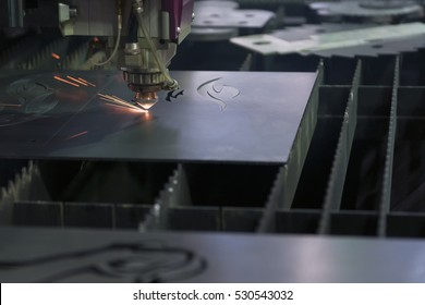 The Laser Cutter Machine While Cutting The Sheet Metal With The Sparking Light