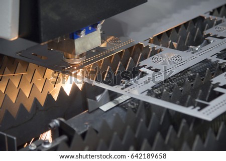 The laser cutter machine while cutting the sheet metal with the sparking light
