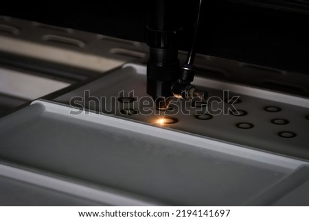 Laser cutting acrylic PMMA. Laser cnc mashine.Laser cutting machine carving patterns on the plastic plate.