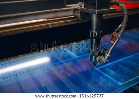 Laser cutting machine carving patterns on the plastic plate