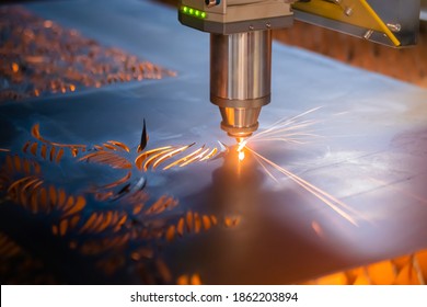 Laser cutting machine working with sheet metal with sparks at factory, plant. Metalworking, industrial, equipment, technology, machining, manufacturing concept