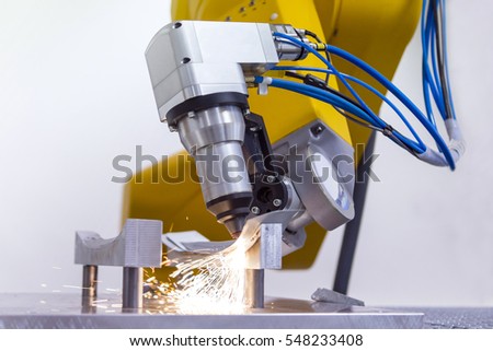 laser cutting of metal on robotic arm with sparks