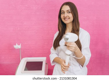 Laser device for removing unwanted hair in the hand of nurse. Laser hair removal, cosmetic body treatments. Concept of beauty. Girl holding a working part of the epilator in hands on pink background - Shutterstock ID 2131081304