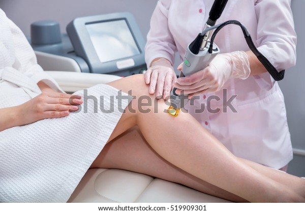 Laser epilation and cosmetology.  Hair removal\
cosmetology procedure. Laser epilation and cosmetology. Cosmetology\
and SPA concept. 