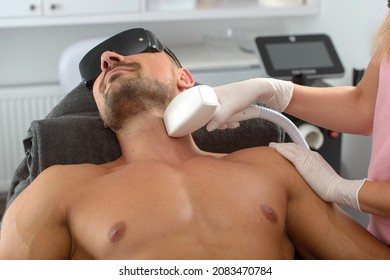 Laser Hair Removal On Mans Neck. Man In A Goggles.