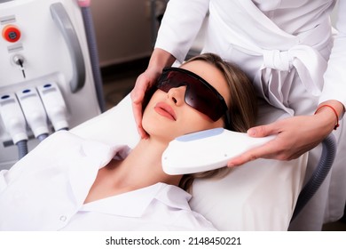 Laser Hair Removal On A Woman's Face In A Beauty Salon. Photo Of A Woman Receiving A Cosmetologist Procedure For Skin Rejuvenation. The Concept Of Aesthetic Medicine. Modern Technologies In Medicine.