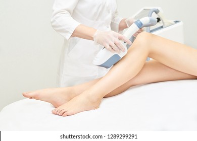 Laser Ipl Device In Doctor Hand. Woman Body Hair Removal. Perfect Epilator. Cosmetology Leg Technology.