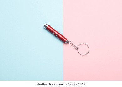 Laser pointer flashlight on pink blue background