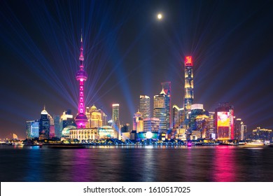 laser show over illuminated Lujiazui skyline and Huangpu river at night, Shanghai, China - Powered by Shutterstock