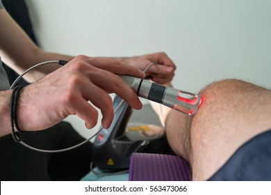 Laser Therapy On A Knee Used To Treat Pain. Selective Focus