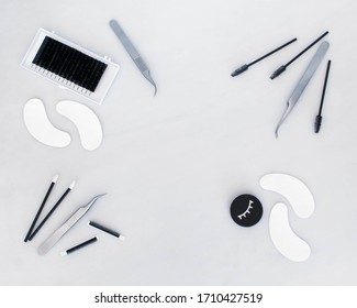 A Lash Artist Beauty Background In A Top Down View With Space For Text. A Plain White Background Shows Off The Variety Of Treatment Products, Tools And Accessories Relating To Eyelash Extensions 