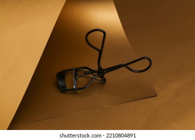 Lash Curler On A Luxurious Golden Background