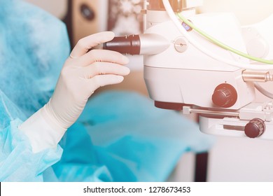 Lasik Treatment. Laser Vision Correction. Doctor Examines Fundus In Microscope, Patient Under Sterile Cover