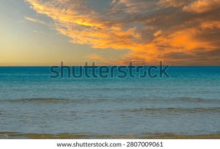 The last beat of light ignites the waves before the silence of the night