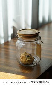 The Last Cookie In The Glass Loading Jar Left On The Table.