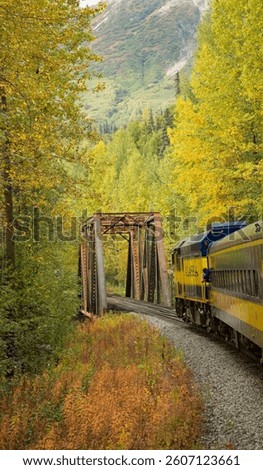 America’s last flag stop train is approaching a Pratt truss bridge on the route to Hurricane gulch bridge, Alaska