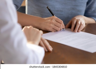 Last Formality. Close Up Of Young Woman Job Applicant Being Hired On Vacant Place Signing Employment Contract In Presence Of Recruiter, Female Bank Client Putting Signature Under Financial Document