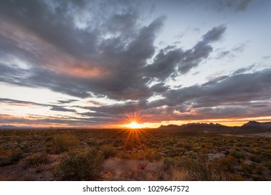 The last glimpse of the setting sun over the vast Sonoran Desert.