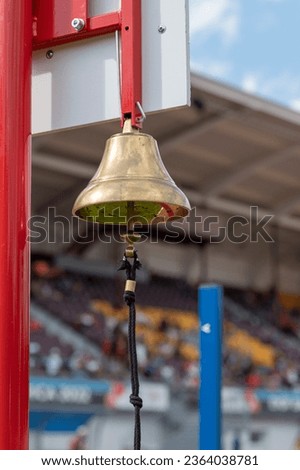 Last lap bell during an athletics race. Brass hand bell.
