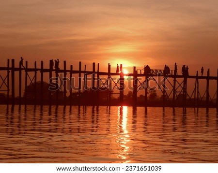 Last light at U Beng Bridge, wooden bridge in Mandalay, Myanmar, Wonderful orange sun set scenery with silhouette