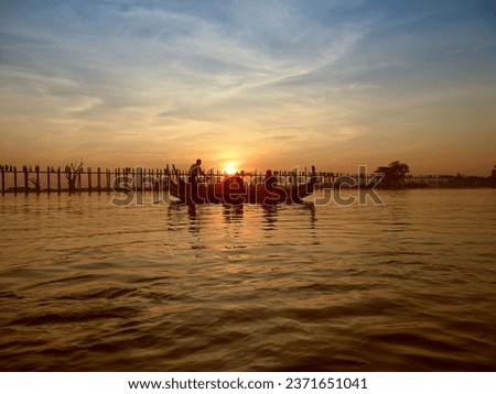 Last light at U Beng Bridge, wooden bridge in Mandalay, Myanmar, Wonderful orange sun set scenery with silhouette