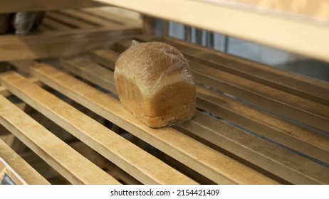 Last Loaf Of Bread On Empty Store Shelf In Grocery. Hoarding, Economic Crisis And Food Shortage