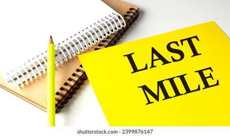 LAST MILE text written on yellow paper with notebook
