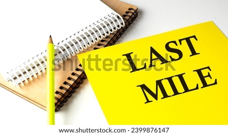 LAST MILE text written on yellow paper with notebook