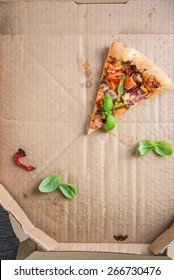 Last One Slice Of Homemade Vegetarian  Pizza In Box From Above