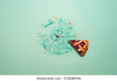 Last Piece Of Blueberry Tart On A Green Table, Above View. Blueberry Pie With Lattice Crust Home-baked. Pie Crumbs And Grease Traces On Green Cardboard