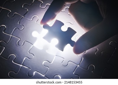 The last piece to place. Conceptual shot of a persons hand building a puzzle. - Shutterstock ID 2148153455
