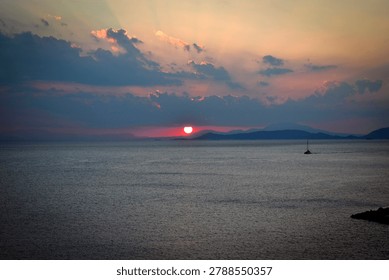 The last rays of the sun setting over the sea horizon