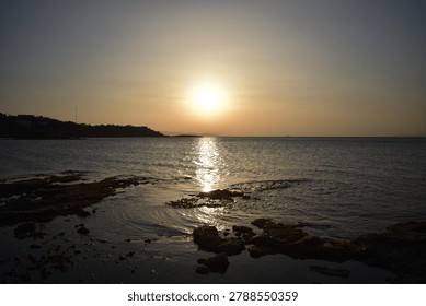 The last rays of the sun setting over the sea horizon