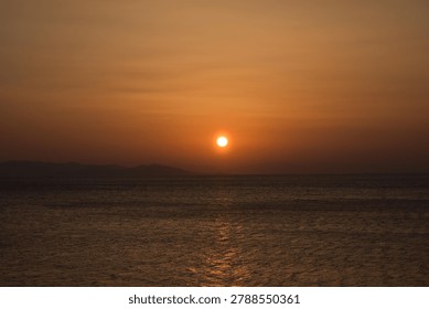 The last rays of the sun setting over the sea horizon