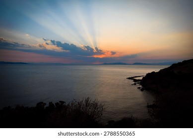 The last rays of the sun setting over the sea horizon