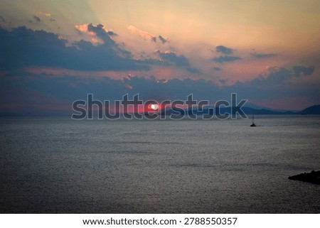 The last rays of the sun setting over the sea horizon