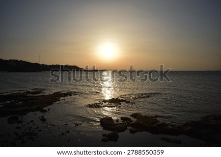 The last rays of the sun setting over the sea horizon